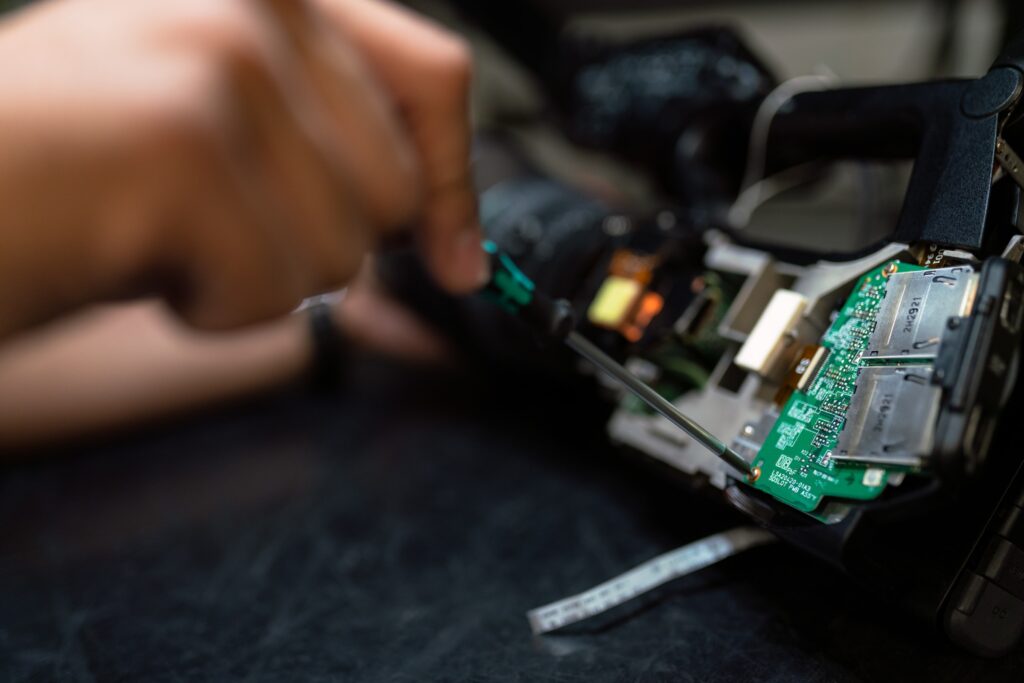 Close-up of the hand of an engineer working on the embedded system's hardware