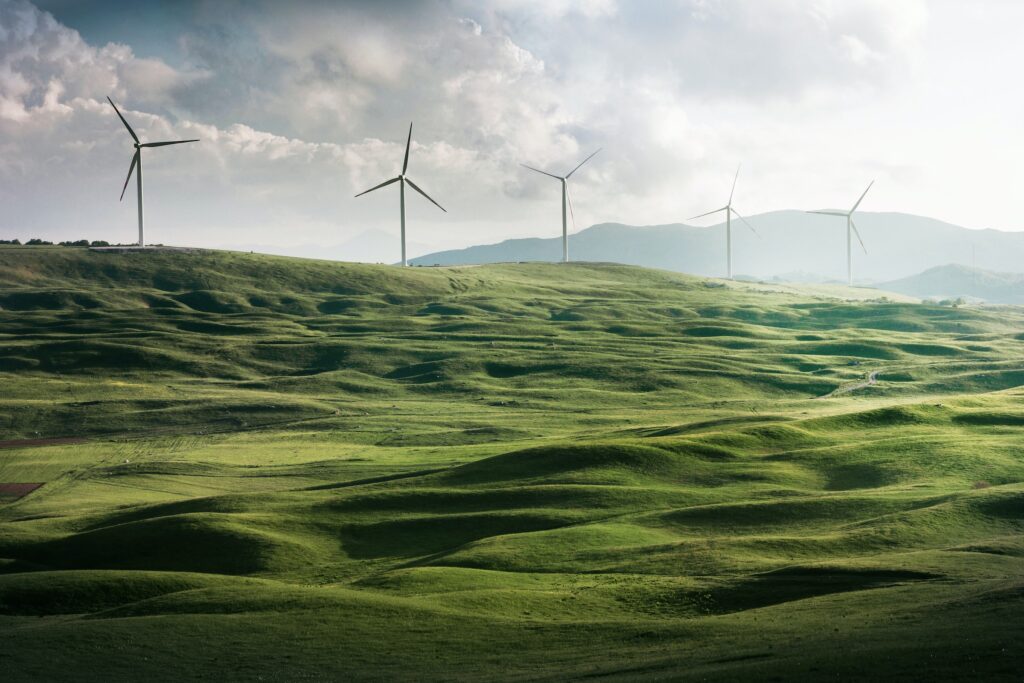 Energy-efficient wind turbines on a green hill. Iot solutions for sustainable development.