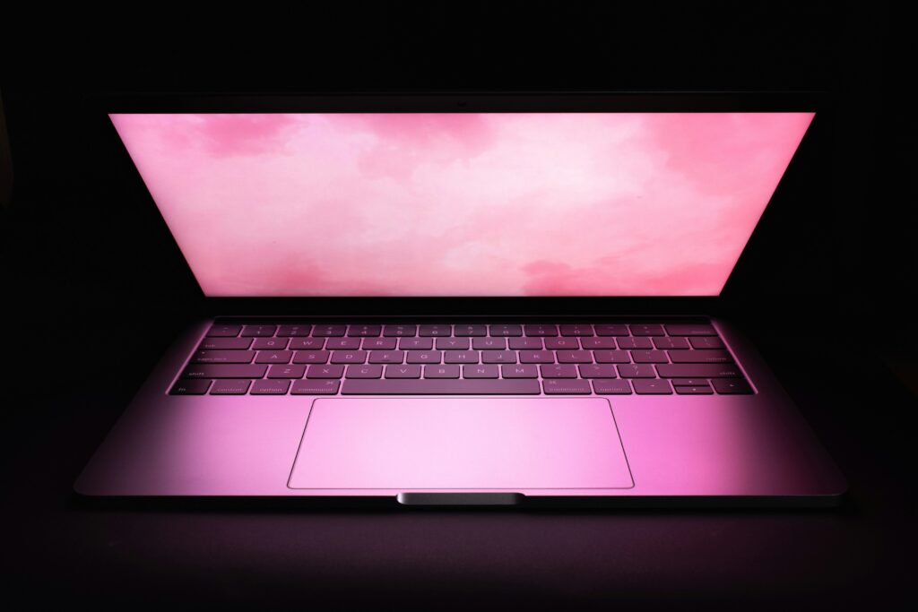 Computer with pink clouds on the screen